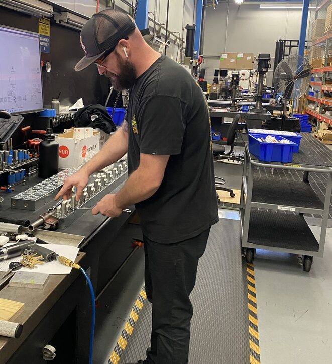 A Hydra Power Systems employee assembling products.