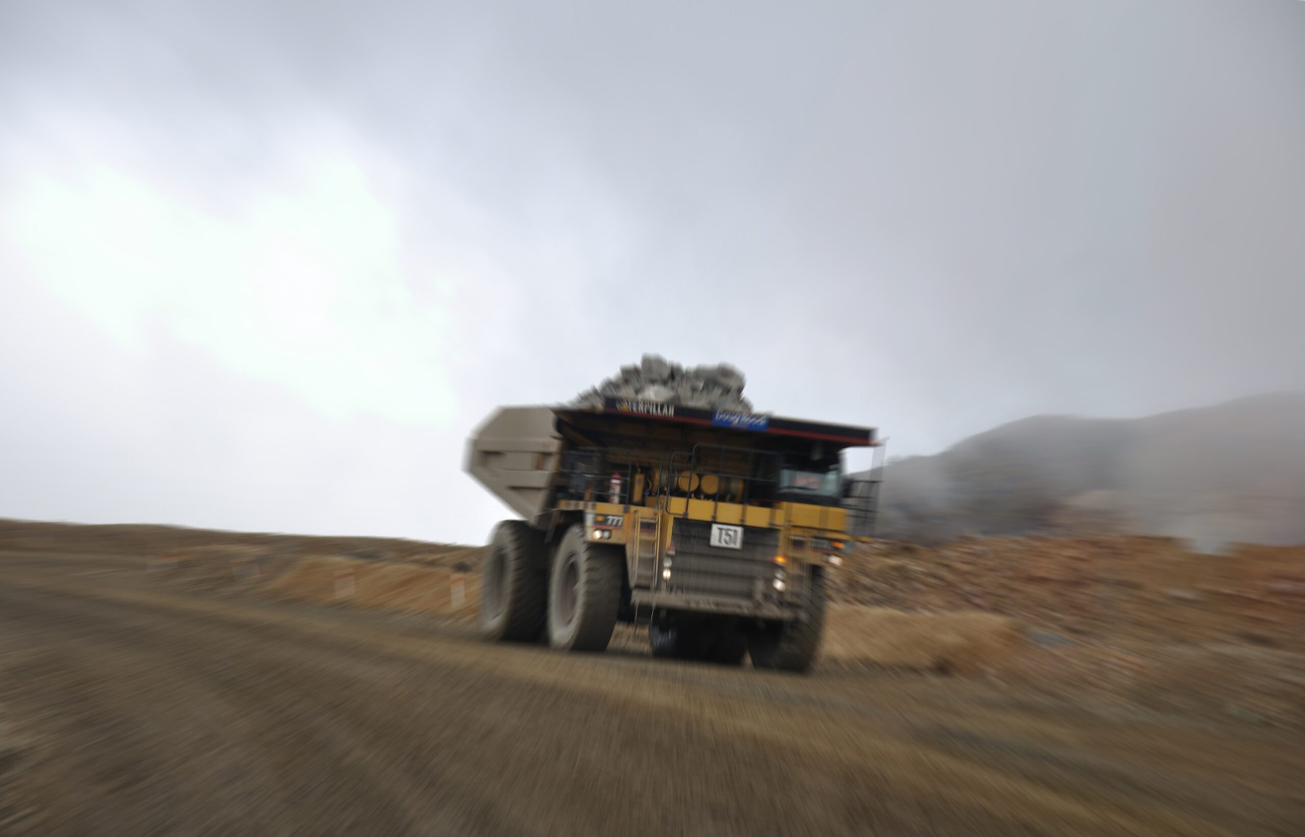 Mining dump truck drives along a quarry road to illustrate Hydraulic Valve Manifolds The Peak of Fluid Power Control
