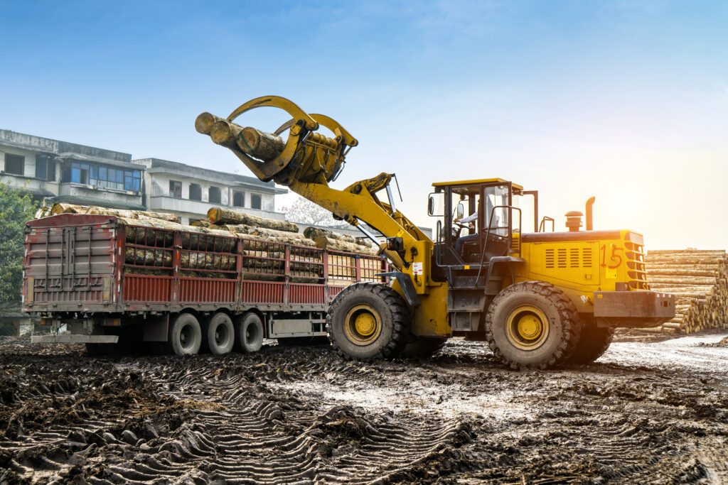 Forklift truck attachment lifting wood in a wood processing plant.
